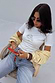 White Oyster Baby T Shirt featuring a fine line oyster and lemon print, styled with denim jeans and a yellow cardigan.