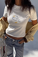 White Oyster Baby T Shirt featuring a fine line oyster and lemon print, styled with blue jeans and a yellow cardigan.