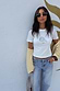 White Oyster Baby T Shirt with a fine line oyster and lemon print, paired with light blue denim jeans.