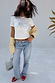 White Oyster Baby T Shirt with oyster and lemon print, styled with blue jeans, a yellow cardigan and red sandals.