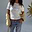 White Oyster Baby T Shirt with lemon print, styled with blue jeans and a yellow cardigan.