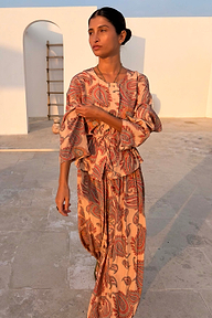 Peach Paisley Anna Top with a tie waist and matching trousers in an outdoor setting.
