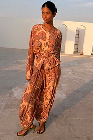 Model wearing the peach Paisley Anna Top with a tie waist and matching trousers.