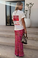 Pink Paisley Dorris Skirt with a bold print, styled with a white graphic t-shirt on stone steps.