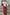 Thumbnail for Pink Paisley Dorris Skirt with a bold print and relaxed midi fit, styled with a white tee and beaded bag.