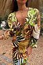 Cream Palm Leaf Emma Dress featuring a tropical palm print, deep V-neck and elasticated sleeves.
