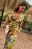 Thumbnail for Cream Palm Leaf Emma Dress with a v-neck and bold tropical print, styled for a summer vacation.