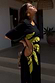 Thumbnail for Black Palm Riviera Dress with lime palm motifs and adjustable cut-out waist detail, ideal for a summer vacation.
