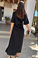 Black Palm Riviera maxi dress in a cotton blend with a waist cut-out and adjustable tie detail, shown from the back.