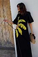 Black Palm Riviera Dress featuring a yellow palm leaf motif and side cut-out with tie detailing.