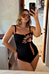 Black Palm Embroidered Bandeau Swimsuit with pink whipstitch trim, shown on a UK size 18 model for inclusive sizing.