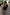 Thumbnail for Black Palm Embroidered Bandeau Swimsuit with pink whipstitch detailing on a model in a vacation setting.