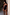 Thumbnail for Black bandeau swimsuit featuring pink palm embroidery and contrast whipstitch trim, styled on a model by a wall.