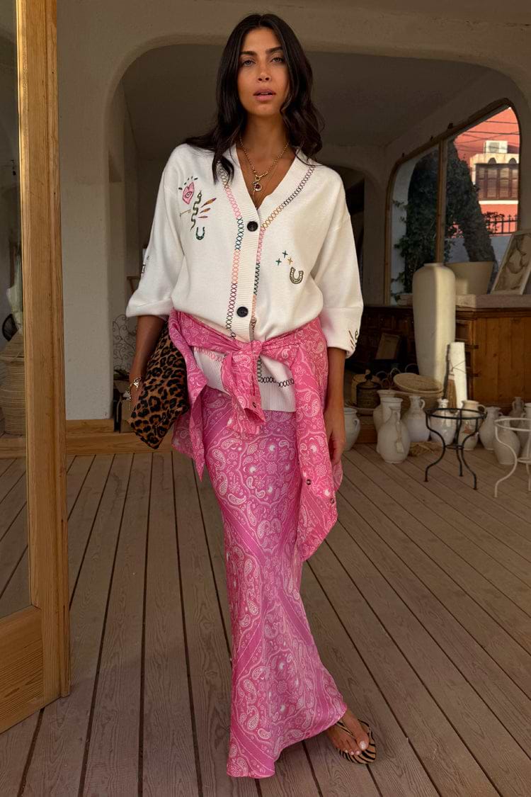Pink Bandana Dorris midi skirt in a bold paisley print, styled with an embroidered white cardigan and leopard clutch.