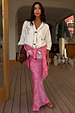 Pink Bandana Dorris midi skirt in a bold paisley print, styled with an embroidered white cardigan and leopard clutch.