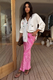 Pink Bandana Dorris Skirt in an iconic paisley print, styled with a white cardigan and animal print accessories.