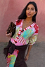 Thumbnail for Pink Dallas Cardigan featuring abstract cowboy motifs and striped trim, styled with a leopard print clutch.