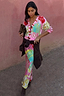 Pink Dallas Cardigan with abstract cowboy motifs and a striped button stand, styled as a matching co-ord set.