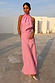 Pink Daphne Skirt with a high-waisted straight fit, styled as a co-ord for a wedding guest look in a sunny setting.