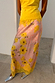 Pink Fawn Poppy Midi Maeva Skirt with yellow floral motifs and contrast lace trim, styled with silver shoes.