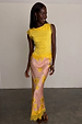 Pink Fawn Poppy Midi Maeva Skirt with yellow lace trim and deer motifs, designed in London and styled with a yellow top.