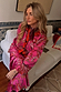 Pink Paisley Oslo Cardigan in a soft knit with red ribbed trims, styled with a matching skirt for a bold London look.