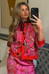 Pink Paisley Oslo Cardigan with red ribbed trims and a boxy fit, styled with a matching skirt in a mirror selfie.