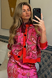 Pink Paisley Oslo Cardigan with red ribbed trims and a boxy fit, styled with a matching skirt in a mirror selfie.