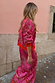 Pink Paisley Oslo Cardigan with an intricate red print and ribbed cuffs, worn as a dopamine dressing co-ord.