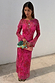 Pink Paisley Mesh Dress with long sleeves and a vibrant print, paired with a colourful beaded clutch bag.