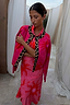 Pink Soleil Cardigan with sun motifs and leopard trim, draped over a model's shoulders in a matching printed dress.