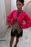 Pink Soleil Cardigan featuring red sun motifs and leopard trim, worn by a 5ft4’’ model in size M with a leopard lace skirt.