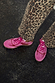 Pink and Red Leather Trainers in a sleek silhouette, paired with leopard print trousers for a street style London look.