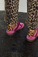 Pink and Red Leather Trainers with leopard print heel tabs, styled with matching leopard print trousers.