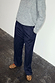 Navy Pinstripe Arden Trousers in a sleek pinstripe print, styled with a grey knit jumper and leopard print shoes.