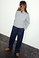 Navy Pinstripe Arden Trousers styled with a grey knit jumper and leopard print shoes for a London look.