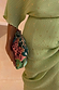 Pistachio Tilly Dress in green stretchy plisse with gold flecks, styled with a colourful beaded clutch.