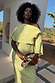 Pistachio Tilly Dress in green plisse with gold flecks, featuring off-the-shoulder styling for wedding guest season.