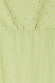 Pistachio green plisse fabric detail of the Tilly Dress featuring subtle gold flecks and an elasticated waistband.