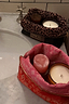 Red Bandana Reversible Make Up Bag designed in-house with a pink interior lining and gold-tone zip on a marble sink.