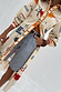 Poema Shirt Dress in cream linen-mix with colourful motifs and orange lace trim, worn open over denim shorts.