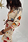Cream Poema Shirt Dress featuring vibrant poem motifs, contrast orange trim and a button-up front.