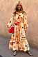 Thumbnail for Poema Shirt Dress in cream with colourful motifs, orange lettuce trim and tie belt, featuring a ruffle hem.