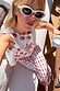 Cream and Red Pollenca Top featuring red scallop edges and palm tree motifs, paired with matching trousers on vacation.