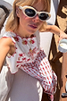 Cream and Red Pollenca Top featuring red scallop edges and palm tree motifs, paired with matching trousers on vacation.