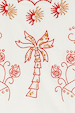 Cream and Red Pollenca Top detail featuring red and gold embroidered palm tree and sun motifs on cotton.