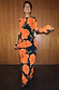 Thumbnail for Black Poppy Aria Mesh Dress with an orange poppy print on sheer black fabric, styled with leopard heels.