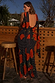 Black Poppy Sophie Dress featuring a red poppy and polka dot print, with a low back and multi-wear scarf detail.