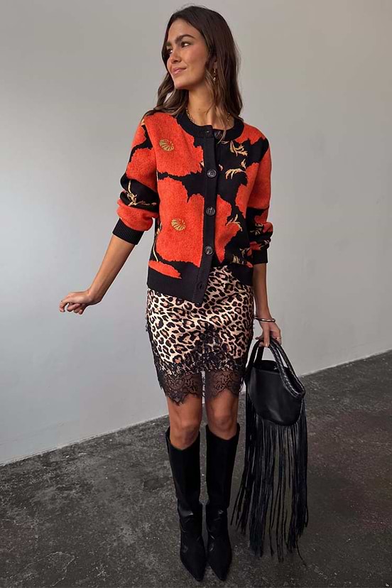 Black Poppy Cardigan with a bold poppy print, button-up front and wide sleeves, styled with a leopard print lace skirt.