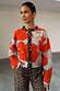 Blue Poppy Cardigan with orange poppy print and leopard trim, styled with leopard print jeans.
